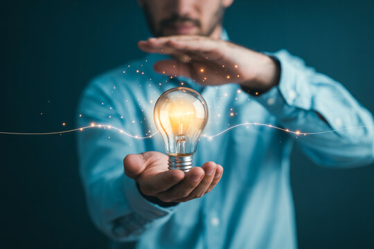 Man holding light bulb idea concept innovation creativity inspiration solution business technology 100