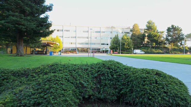 Panning view through CSU East Bay offers a dynamic look at glass-fronted buildings and landscaped quads.
