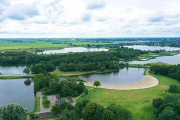 Fototapeta premium Aerial view of De Alde Feanen National Park in the Dutch province of Friesland. The park offers a diverse landscape with moors, heathlands, and open water. Leeuwarden, Netherlands