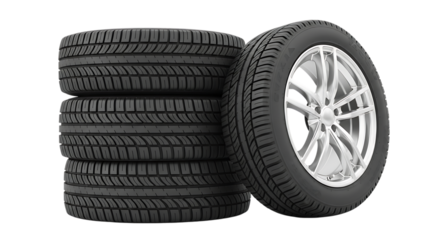 Stack of new car tires and one tire mounted on a silver alloy wheel isolated on white background