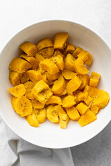 overhead view of Boiled ripe plantain in a white bowl, top view of nigerian cooked ripe plantain