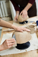 Young couple enjoys a creative pottery session in a cozy studio together