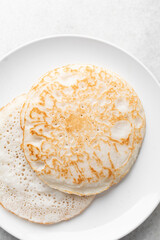 Overhead view of a plate of sinasir, top view of food from northern nigeria sinasir rice pancake