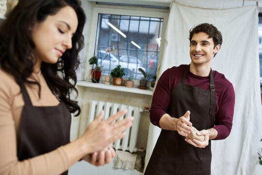 Young couple creating pottery in a cozy studio while enjoying each others company