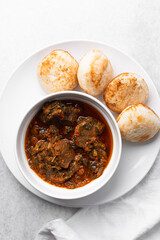 Overhead view of a plate of masa and miyan taushe, top view of food from northern nigeria masa and taushe