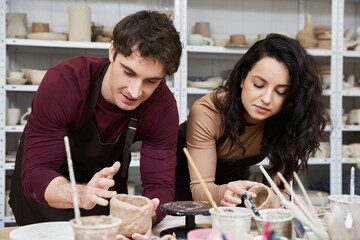 Fototapeta premium Creating beautiful pottery together in a cozy studio setting