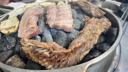 Grilled meat on hot stoned