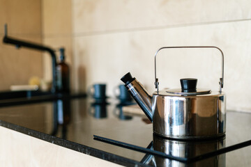 Modern kitchen with sleek wooden furniture and a stylish kettle on the counter