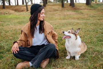 Owner and their dog walking together outdoors, enjoying a walk and caring for the pet in nature.