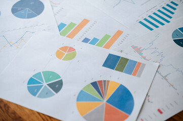 Top view documents with analytics data on table.