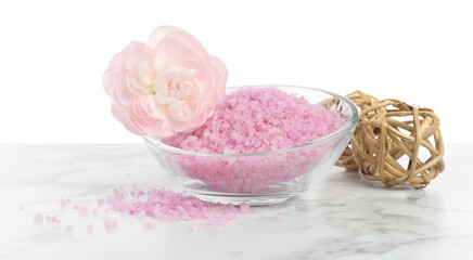 Pink sea salt in bowl and beautiful flower on marble table against white background