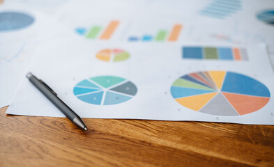 Top view documents with analytics data on table.