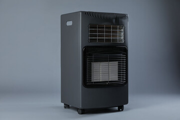 Obraz premium One electric heater on grey background. Domestic appliance