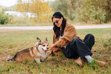 Owner and their dog walking together outdoors, enjoying a walk and caring for the pet in nature.
