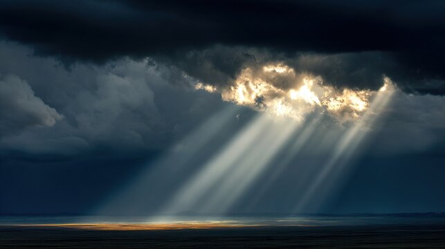 darkness. Beam of sunlight breaking through dark storm clouds, illuminating the ground. travel magazines, destination branding, designed for outdoor magazines and nature guides.