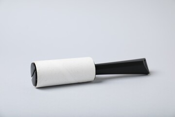 One lint roller on light grey background