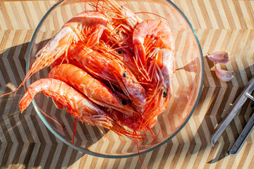 Glowing shrimp nestle in a glass bowl, evoking Lunar New Year feasts and coastal twilight culinary...