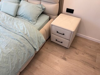 Comfortable bed with luxury bedding and stylish nightstand in bedroom