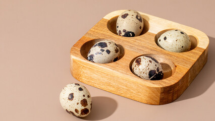 Speckled quail eggs rest in a rustic wooden tray, evoking rustic brunches and Easter festivities...