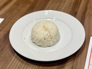 Steamed white rice neatly molded and served on a clean white plate — a staple food in Indonesian and Asian cuisine, often paired with various side dishes. October 2, 2025 - Jakarta, Indonesia