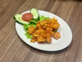 Crispy fried chicken coated in creamy salted egg sauce (ayam telur asin), a savory Indonesian-Chinese fusion dish with a rich, buttery flavor and golden coating. October 2, 2025 - Jakarta, Indonesia