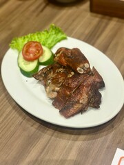 Delicious roasted duck with crispy skin and tender meat, served on a plate. A popular Asian dish known for its rich flavor and aromatic seasoning. October 2, 2025 - Jakarta, Indonesia
