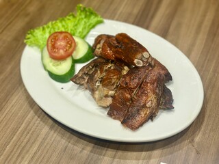 Delicious roasted duck with crispy skin and tender meat, served on a plate. A popular Asian dish known for its rich flavor and aromatic seasoning. October 2, 2025 - Jakarta, Indonesia