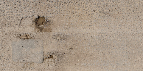view from above on texture of asphalt road surface with cracks