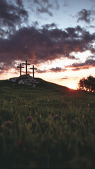 Sunset view of three crosses on a hill symbolizing faith and hope in Christianity