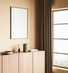 Minimalist interior with blank poster on beige wall, wooden cabinet, books and decor, next to window and curtain, clean layout for design mockup. 3D Rendering