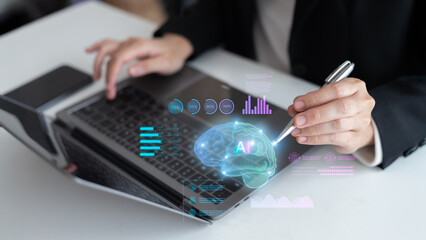 Artificial intelligence and data analytics concept showing a business person using laptop with a digital brain AI hologram, charts, and graphs, representing innovation and machine learning technology.