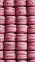 Rows of dark pink macarons forming a pastel dessert pattern