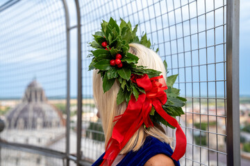 Proud graduate girl celebrating academic success with laurel garland near Pisa Tower landmark