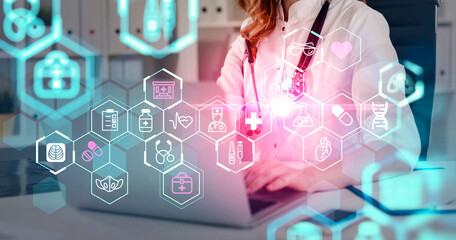 Female doctor working on laptop with glowing medical icons in a futuristic interface, creative concept on blurred clinical background for digital healthcare