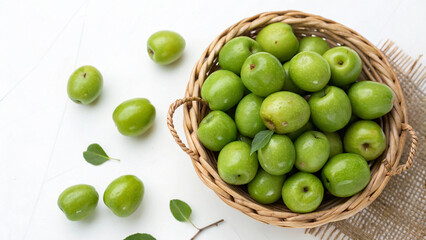 Green Jujubes in wicker basket on white surface isolated on white background Top View