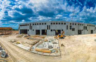 Wide aerial perspective of an active building site showing structures under development