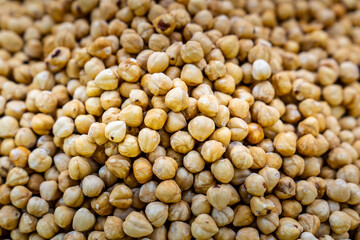 Roasted, unshelled hazelnuts. Top view on a counter.