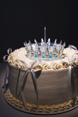 Elegant cake with crown and candle for a special celebration