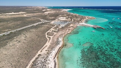 Aerial view of Coral Bay and beach in Western Australia with turquoise ocean and white sand