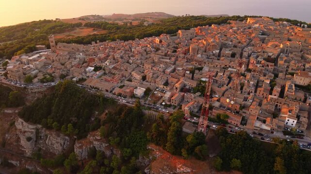 Erice Village With Transmission Towers And Tyrrhenian Coast In The Background At Sunset In Sicily, Italy. - aerial shot