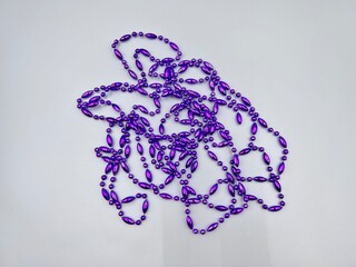 purple Christmas tree beads scattered on the surface