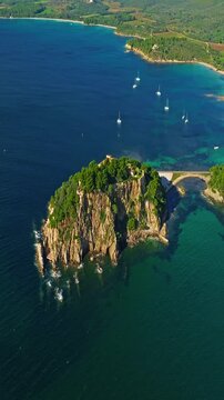  Aerial view of Fort Bregancon sunset aerial view from the mediterranean sea. A yacht is anchored near the fortress