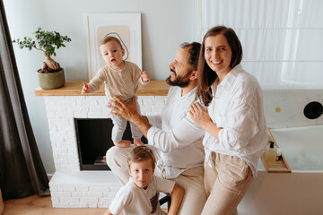 Parents and children enjoying happy family moments at home