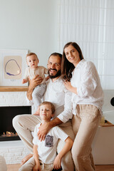 Happy family with parents and two young children posing