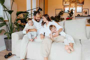 Happy family relaxing together on couch at home