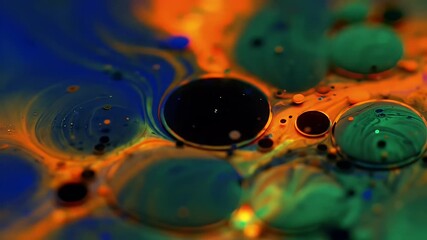 Macro shot of colorful liquids with bubbles and swirls.