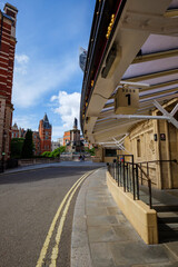 London - 06 25 2022: View of the secondary entrance on Loverose Street to the Royal Albert Hall, with the Great Exhibition Memorial in the background.
