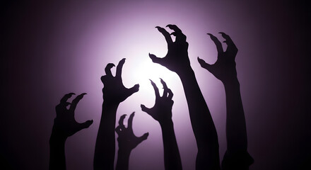 Silhouette of creepy zombie hands reaching out from the darkness against a purple background, creating a spooky and eerie halloween atmosphere