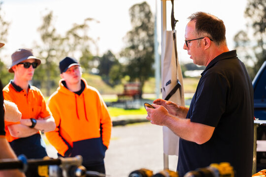 instructor holding angle grinder cutting disc talking about safety when using tools