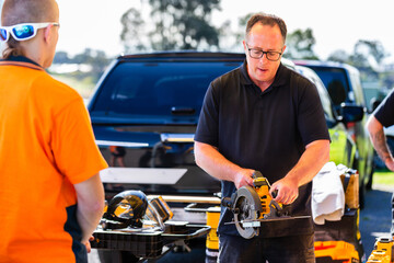 Australian man doing tool demonstration for trade student talking about safe use of circular saw